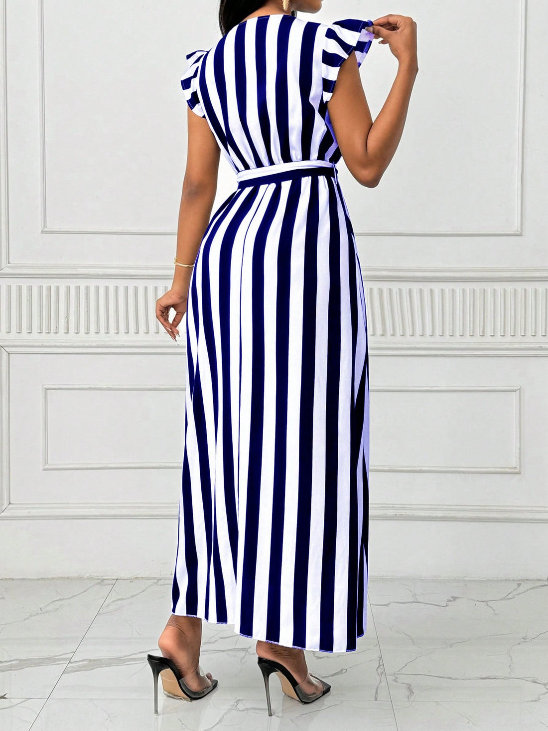 Step out in style with our Elegant Cinched Waist Maxi Dress. Featuring a flattering bow tie detail and eye-catching vertical stripes, this dress is perfect for any occasion. Plus, the cinched waist will accentuate your figure for a confident and elegant look. Own the room with this dress today!