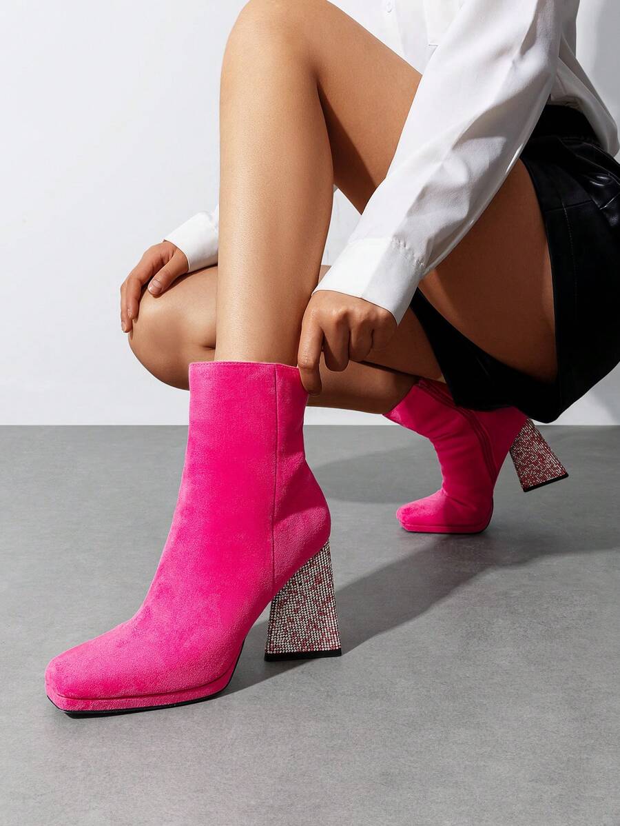 Step into the spotlight with these dazzling chunky heeled ankle boots that turn heads at every celebration. Adorned with eye-catching rhinestones that sparkle under party lights, these boots deliver glamour without sacrificing comfort. The sturdy chunky heel keeps you steady all night long, while the convenient side zipper makes slipping them on and off effortless. Whether you're dancing at a holiday bash or making a grand entrance, these statement boots are your ticket to feeling fabulous and looking absol