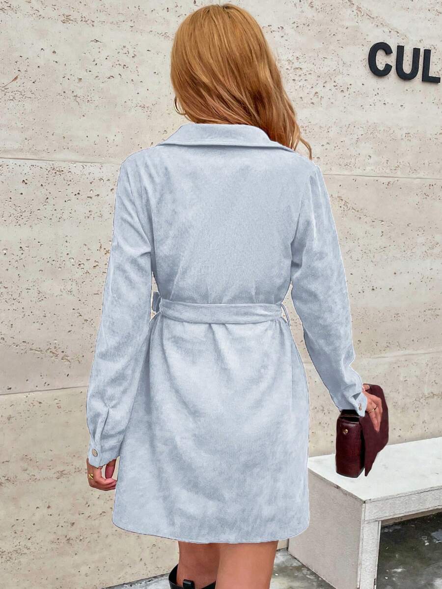Effortlessly elevate your style and comfort with our Chic Flap Detail Belted Corduroy Shirt Dress. The belted waist cinches to accentuate your figure, while the flap detailing adds a touch of sophistication. Made from soft corduroy, this dress offers both style and comfort.