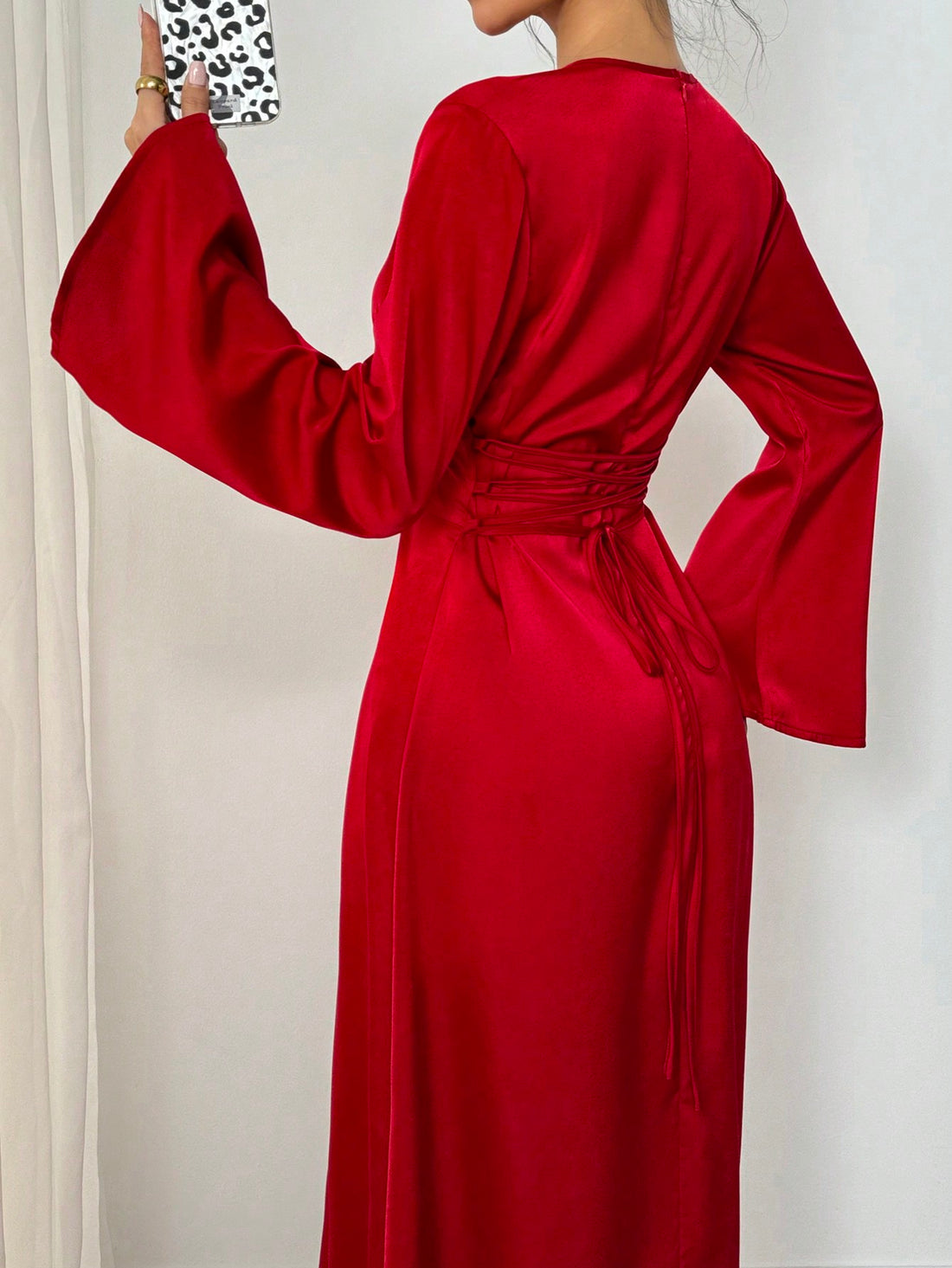 Step into the holiday season with our Elegant Flared Sleeve Cross Waist Tie-Back Dress. Showcasing flared sleeves and a cross waist tie-back design, this dress is perfect for all your holiday celebrations. Crafted with elegance and style in mind, this dress will make you stand out from the crowd.
