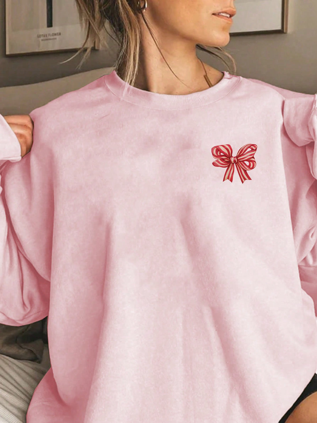 Display your holiday spirit in our Festive Flair Graphic Pullover Sweatshirt for women. Featuring a festive bow graphic, this sweatshirt is perfect for spreading Christmas cheer while staying cozy and comfortable. Made with soft and durable materials, it's the perfect addition to your holiday wardrobe.