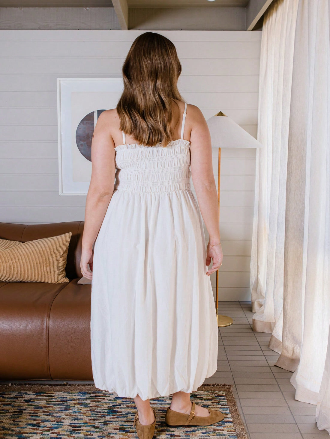 Step out in style with this playful midi dress featuring a shirred bodice that hugs your curves and a bubble hem that adds a fun, flirty bounce to every move. Perfect for effortless elegance, it blends comfort and chic for days when you want to feel fabulous without trying too hard.