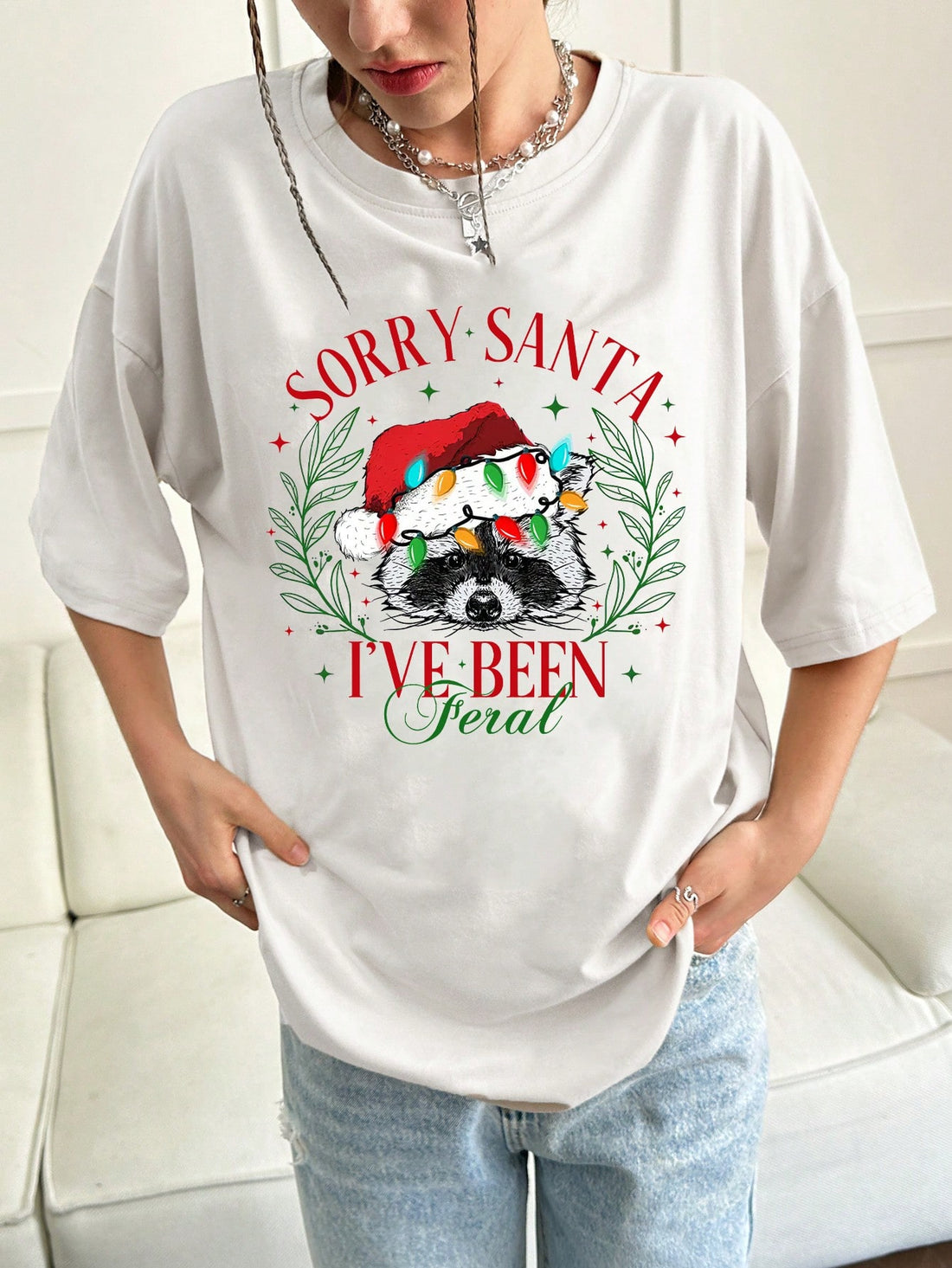 Indulge in the festive spirit with our Christmas raccoon slogan graphic tee for women. With a cute and trendy design, this tee is perfect for spreading holiday cheer. Made with high-quality materials, it offers comfort and durability. Get into the Christmas spirit with this must-have addition to your wardrobe.
