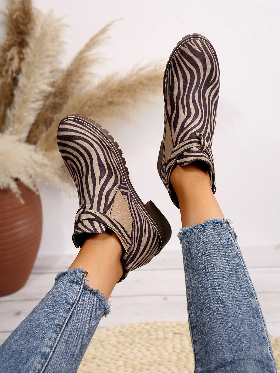 Introducing our Chic Zebra Print Chunky Low Heel Boots - the perfect versatile fashion choice for the autumn and winter seasons. These boots are not only stylish with their trendy zebra print design, but also comfortable with a low heel and perfect for any occasion. Upgrade your shoe collection with these must-have boots.