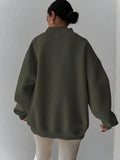 Back view of dark green oversized sweatshirt with wide rib-knit hem and cuffs