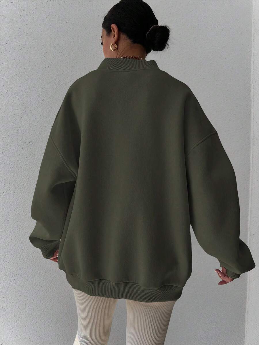 Back view of dark green oversized sweatshirt with wide rib-knit hem and cuffs