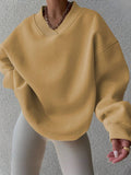 Front view of yellow oversized V-neck sweatshirt with dropped shoulders