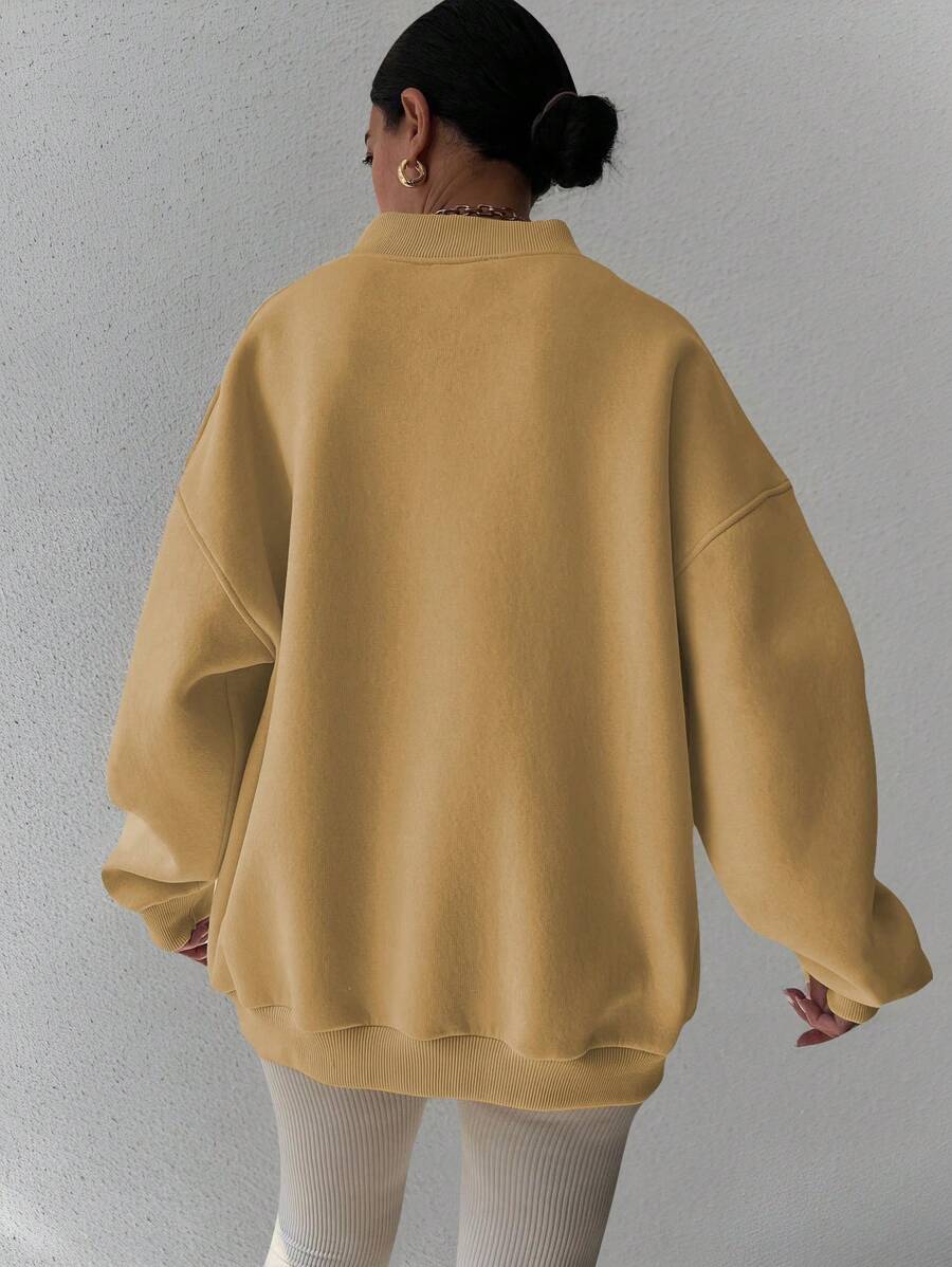 Back view of yellow oversized sweatshirt with balloon sleeves and rib-knit cuffs