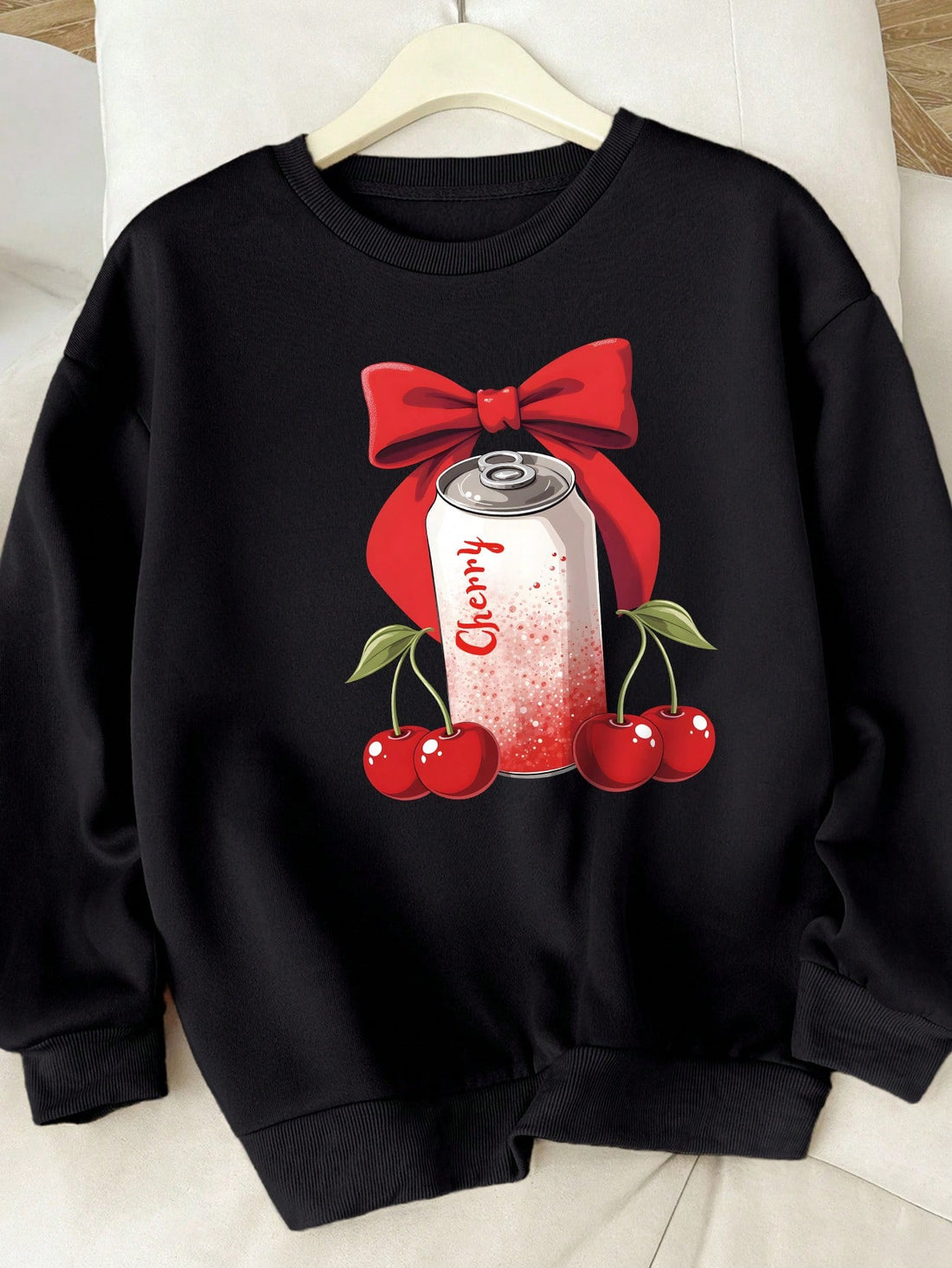 Enhance your casual look with our Cherry Delight: Bow Print Sweatshirt. With an adorable bow print, this sweatshirt exudes a sweet and playful vibe. Made with high-quality fabric, you can enjoy both style and comfort. Perfect for any casual occasion, this sweatshirt will surely be your new favorite.