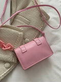 Front style view of mini bag in beige tone with chain accent