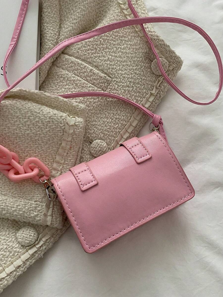 Front style view of mini bag in beige tone with chain accent