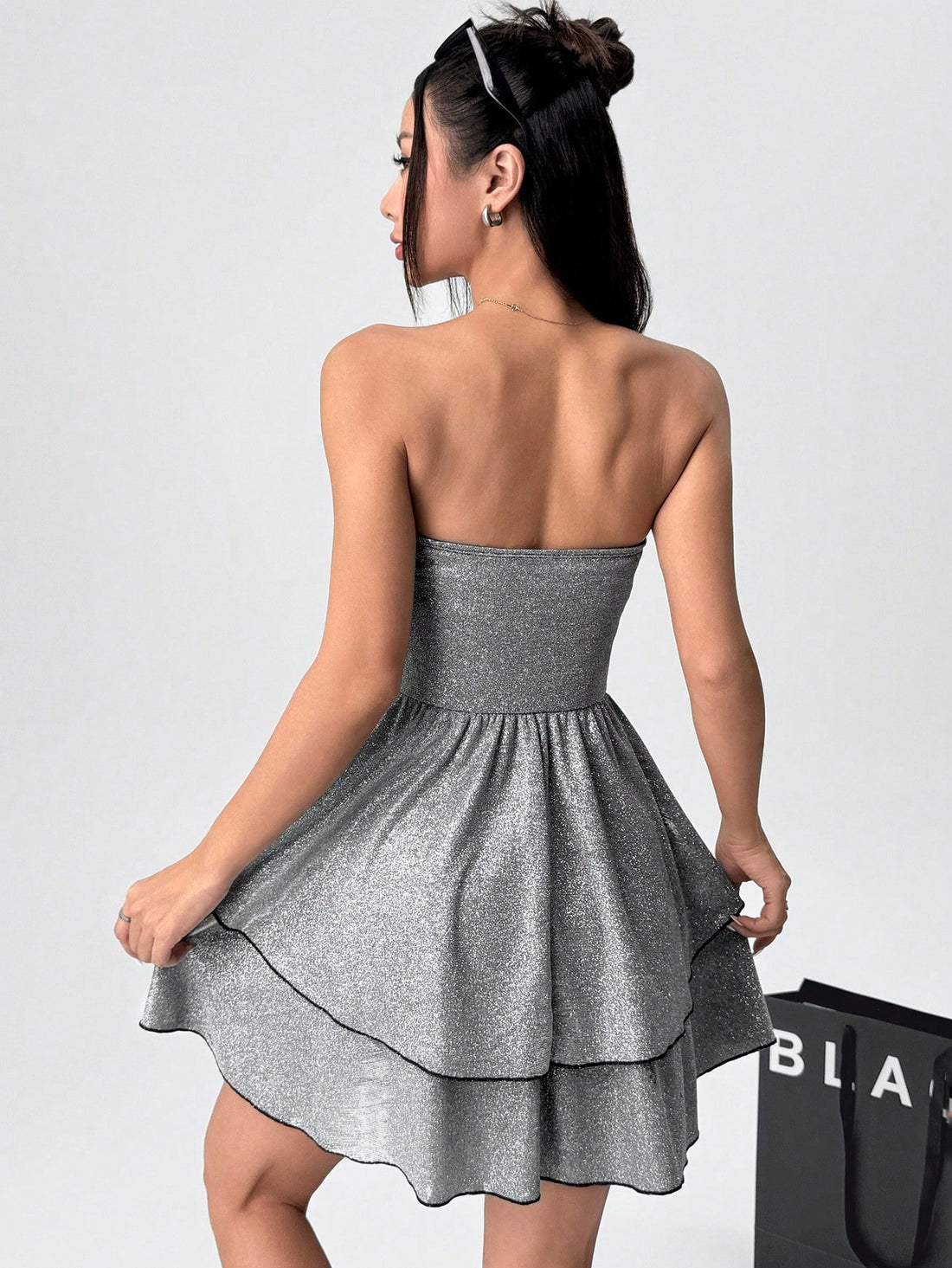 Discover the perfect dress for any occasion with our Shiny Ruffle Bandeau Mini Dress. Designed to be both chic and trendy, this dress will make you stand out in any crowd. The shiny fabric and ruffle detail add a touch of glamour, while the bandeau style shows off your shoulders. Elevate your fashion game and turn heads wherever you go!