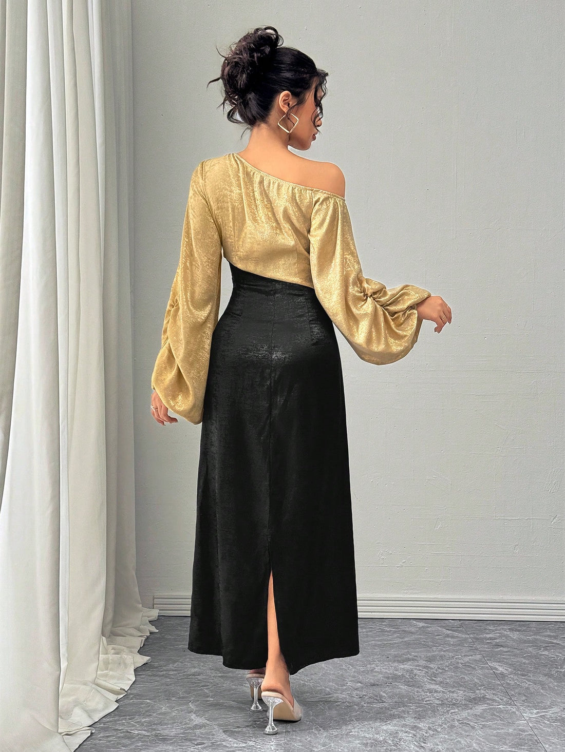 This elegant dress features chic asymmetrical lantern sleeves, creating an edgy yet sophisticated look. The midi length adds a touch of modernity, while the overall design exudes grace and charm. Perfect for any occasion, this dress is a must-have for those who want to make a statement.