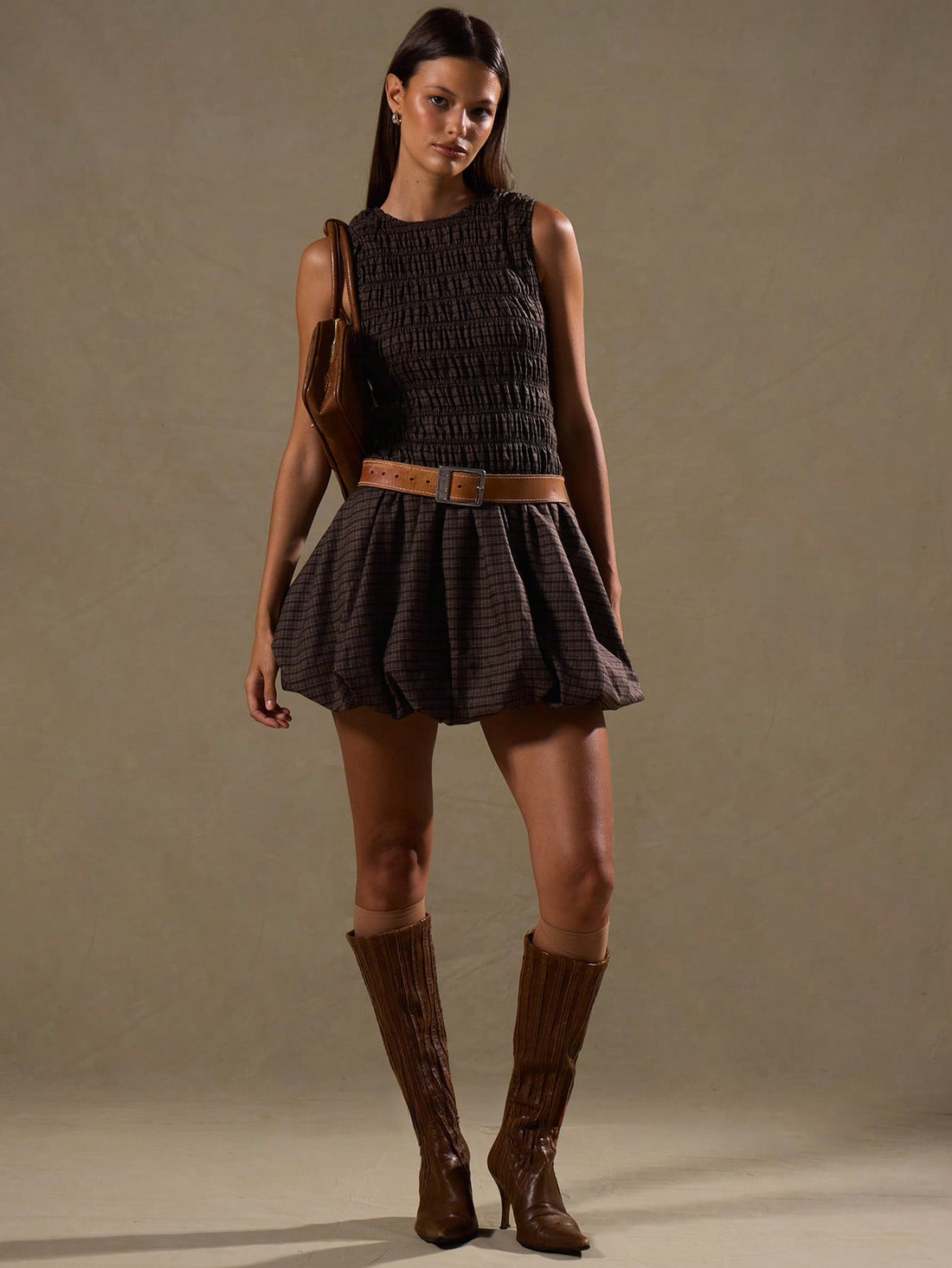 Step into style with the Chic Plaid Ruched Puffball Dress, a playful take on classic elegance. This sleeveless sundress features a charming ruched bodice and a voluminous puffball skirt that dances with every step. Perfect for layering or wearing solo, it brings a fresh twist to your wardrobe year-round. Whether it’s a sunny day or layered for cooler nights, this dress promises fun, flirty fashion with a dash of timeless plaid flair.