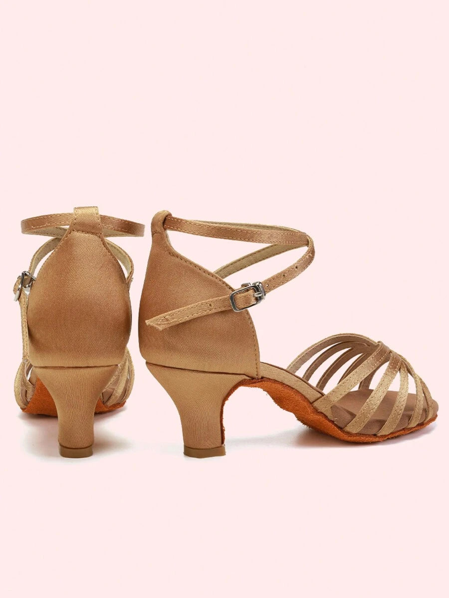 Elevate your ballroom experience with these sophisticated women's dance heels, designed for Latin and Salsa performances. Crafted from luxurious satin with a peep-toe silhouette, these mid-heel shoes feature a secure buckle closure and pyramid heel for optimal balance and support. The suedette outsole provides excellent grip on the dance floor, while the fabric lining and insole ensure comfort during extended wear. Available in elegant beige, these heels fit half-size larger for a perfect fit. Ideal for dan