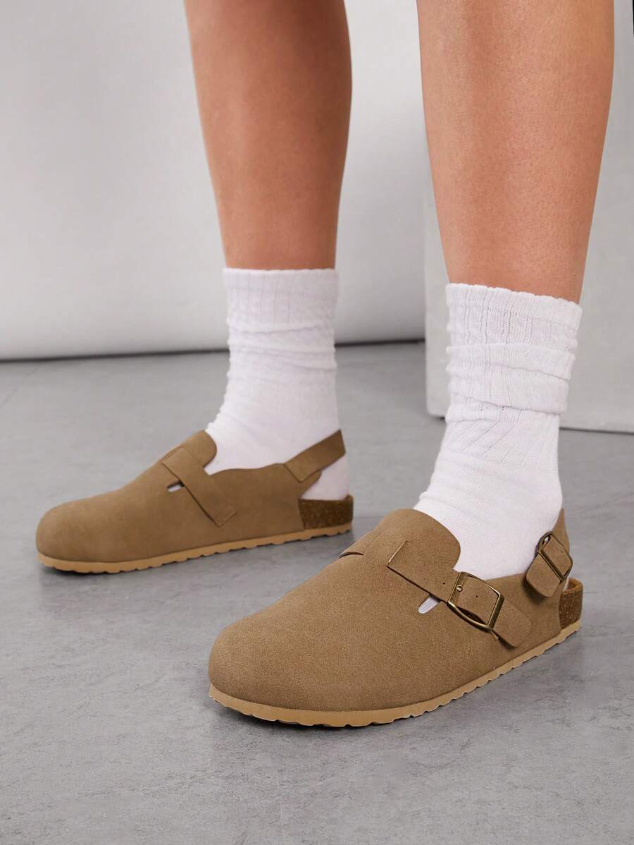 Women’s beige buckle clogs close up front view
