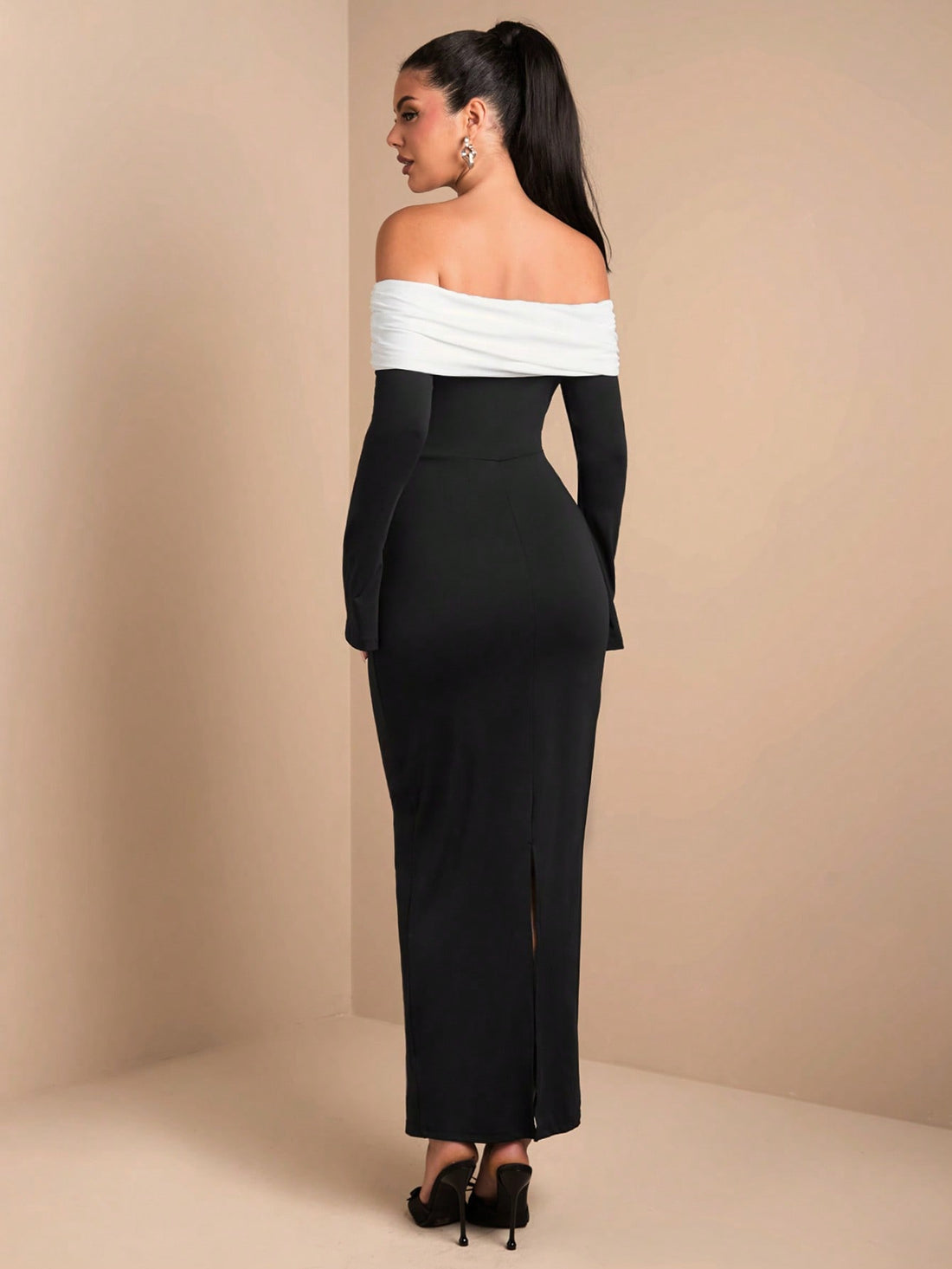 Be the center of attention at any winter celebration or formal event in this elegant black and white off-shoulder bodycon dress. With its flattering design and sleek silhouette, you'll be turning heads all night long. Perfect for standing out in a sea of boring dresses.
