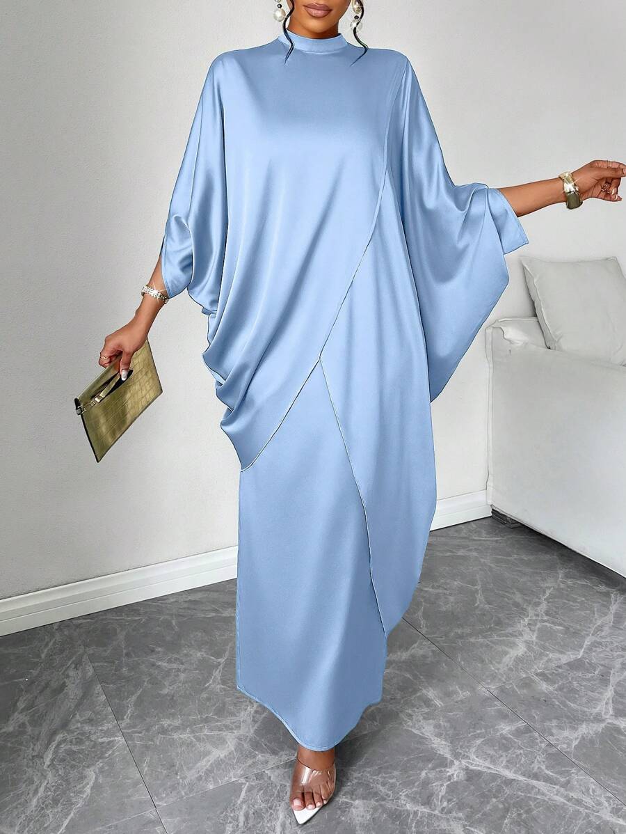 Effortless elegance meets everyday comfort in this charming two-piece set. The relaxed batwing sleeves add a touch of drama to the oversized shirt, while the flowing skirt keeps things breezy and laid-back. Perfect for those days when you want to look put-together without trying too hard—just slip it on and go. Whether you're running errands or meeting friends for coffee, this minimalist pairing strikes that sweet spot between casual and chic. A wardrobe staple that works as hard as you do.