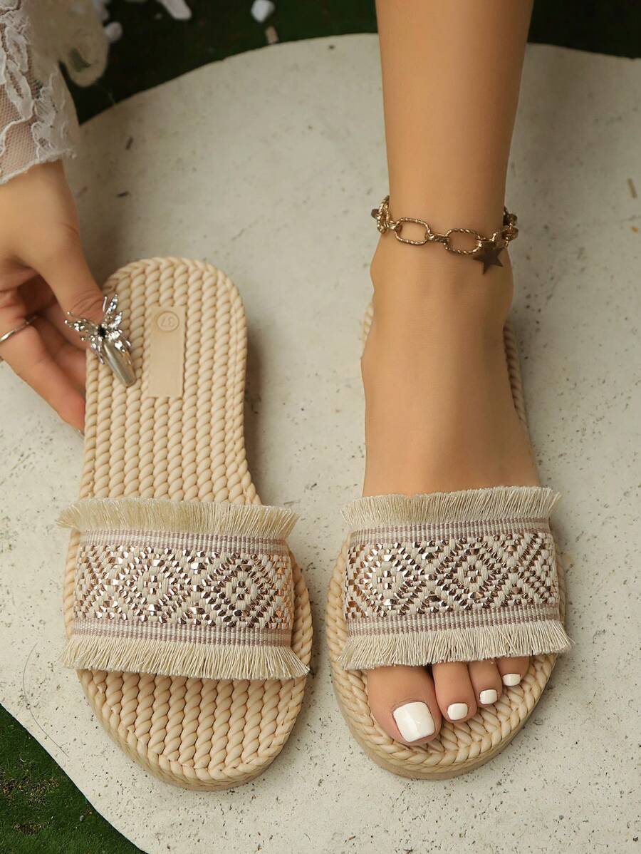Overhead pair view of beige platform slides with braided footbeds and fringed vamps