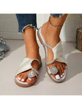 Top view of white flat slide sandals with jeweled toe loop and rhinestone trim