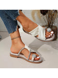 White rhinestone thong slide sandals with ribbed crossover straps and flat tan sole