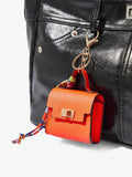 Close-up view of mini key ring holder keychain coin purse earphone pouch bag charm with chain strap, coin purse format, key ring detail for small-item storage