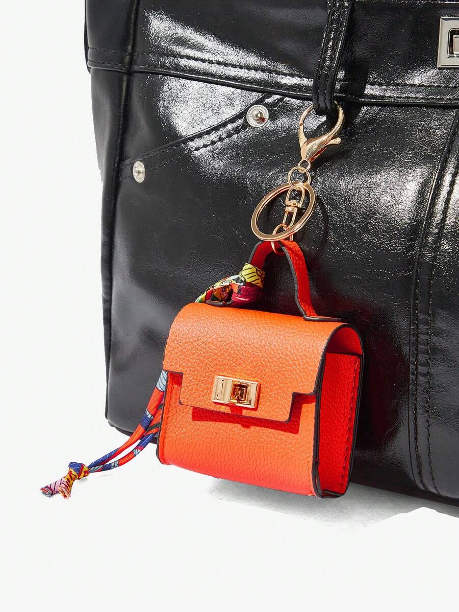 Close-up view of mini key ring holder keychain coin purse earphone pouch bag charm with chain strap, coin purse format, key ring detail for small-item storage
