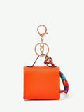 Close-up view of mini key ring holder keychain coin purse earphone pouch bag charm with chain strap, coin purse format, key ring detail for small-item storage