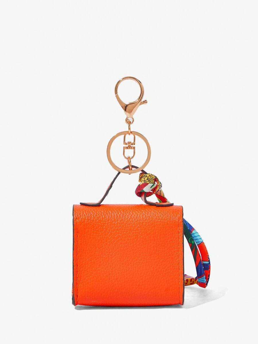 Close-up view of mini key ring holder keychain coin purse earphone pouch bag charm with chain strap, coin purse format, key ring detail for small-item storage