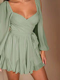 Close-up sage green chiffon mini dress with ruched wrap bodice side tie sheer sleeve and ruffle hem