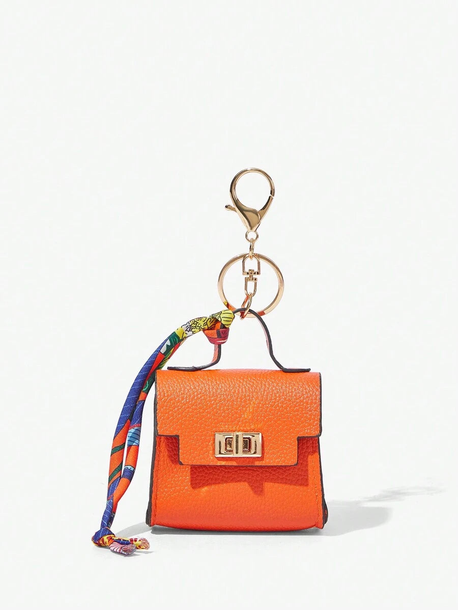 Close-up view of mini key ring holder keychain coin purse earphone pouch bag charm with chain strap, coin purse format, key ring detail for small-item storage