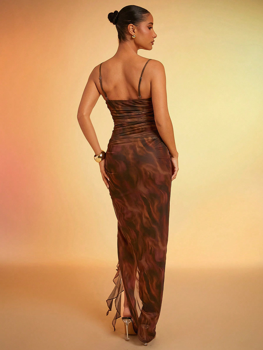 This stunning Chic & Flowy dress features a bold abstract print and a flowy mesh ruffle design. The maxi length and cami style create a flattering silhouette for any occasion. Be the center of attention and unleash your inner fashionista with this must-have dress!