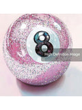 Close-up of pink glitter-style 8-ball artwork showing multicolor speckles and brush texture
