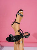 Black patent low heel slide sandals with rhinestone front strap and open toe