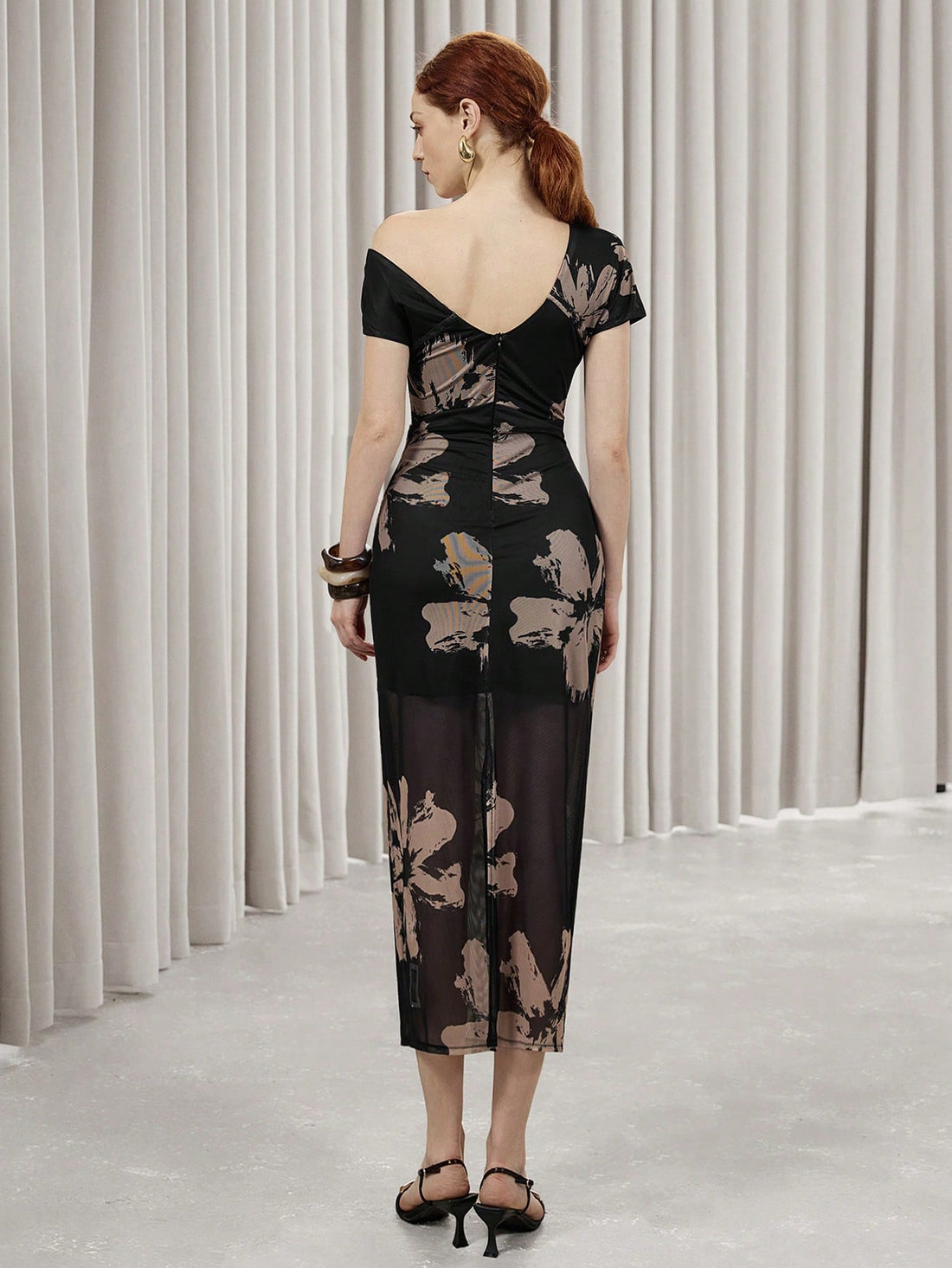 Be the center of attention with the Elegant Asymmetrical Floral Mesh Bodycon Dress by Aveloria Modichic. This stunning dress features a unique, asymmetrical design and beautiful floral mesh detailing that will surely turn heads. Perfect for any special occasion, this dress will make you feel confident and stylish.