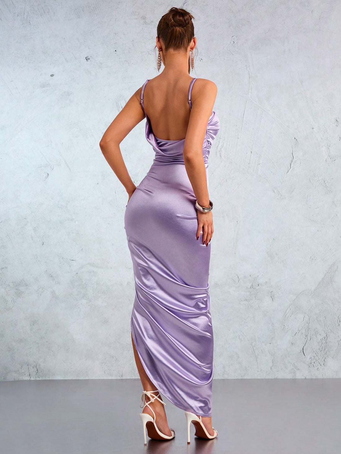 Unleash your elegance with this lilac satin halter dress featuring a high slit and backless design. Elevate your style game with a touch of playful sophistication. (2 exclamation points)
