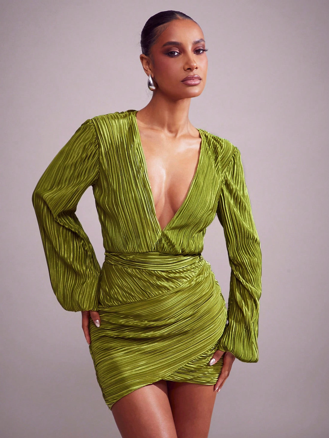 Get ready to turn heads in this Chic Satin Pleated Green Mini Dress! With a daring Plunge Neck and playful Tulip Hem, this dress is perfect for any festive occasion. Made from luxurious satin fabric, it's sure to make you feel chic and stylish. Make a statement and stand out from the crowd with this unique and fun mini dress.