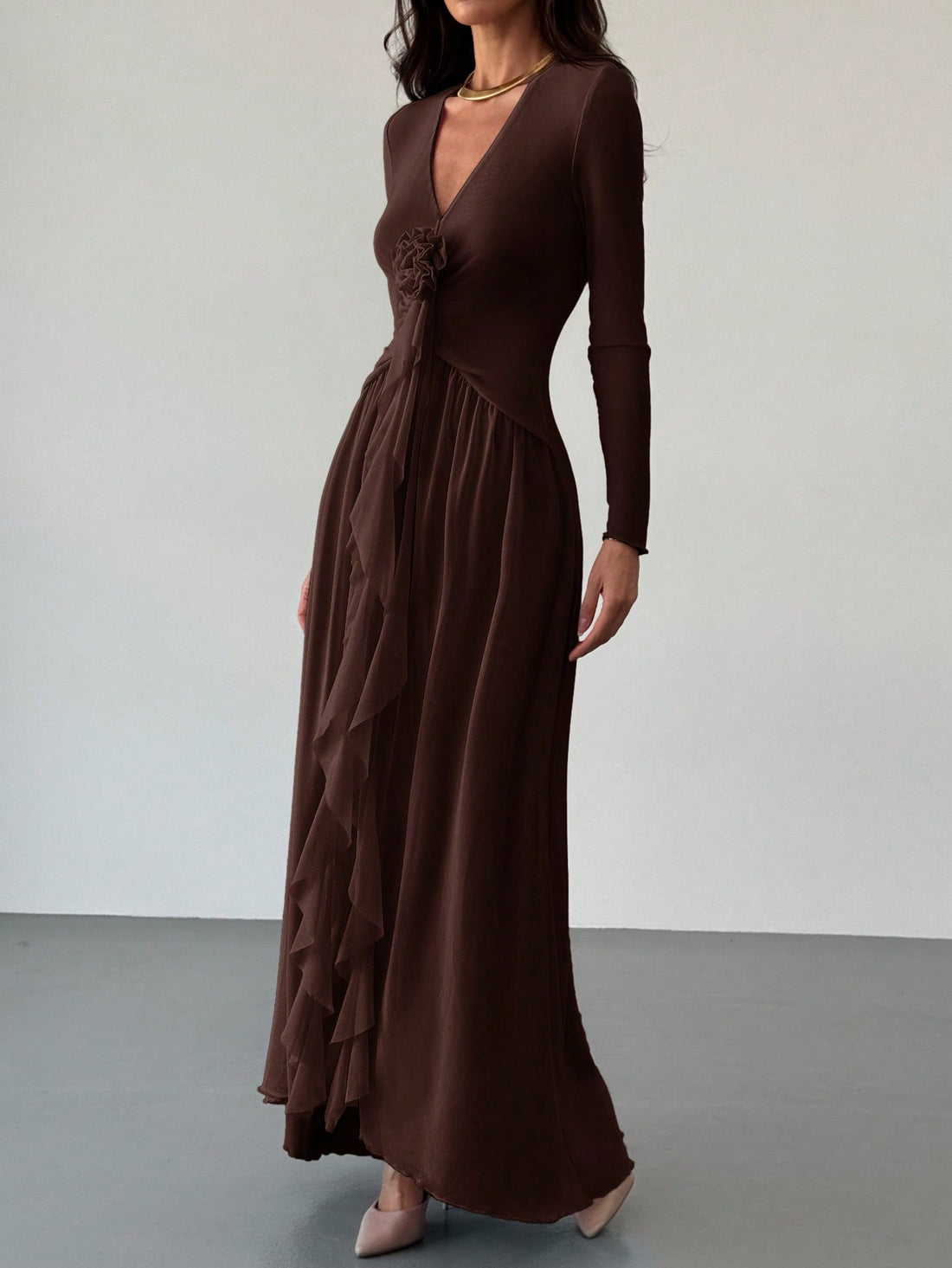 Unleash your inner romance with this elegant and playful dress featuring ruffled floral accents and a plunging v-neck. Perfect for a date night or special occasion, this sheer dress will make you feel beautiful and confident. Embrace your unique style and stand out in a crowd!