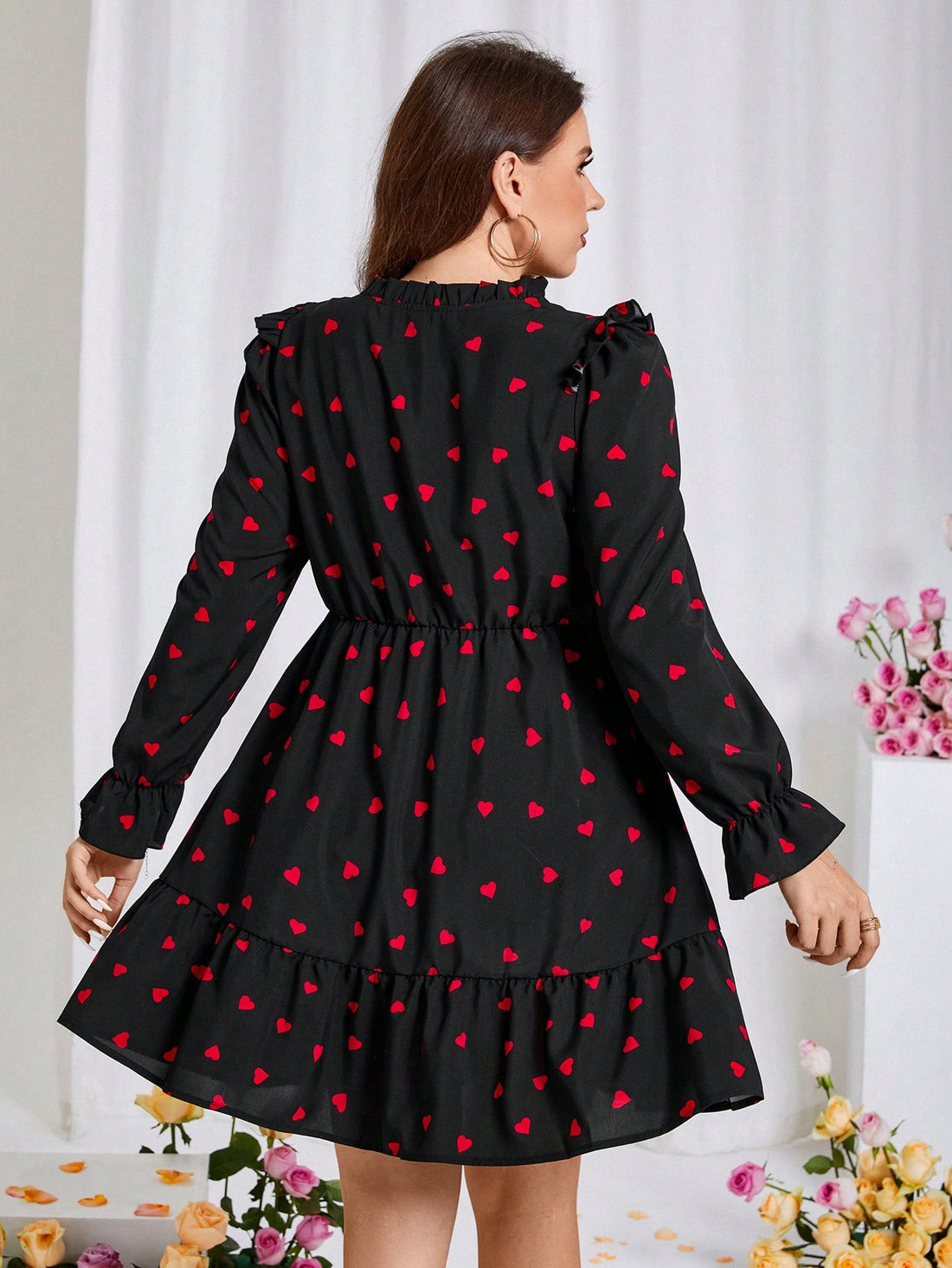 Get ready to charm your way through spring and Valentine's Day in this Charming Plus Size Heart Print Dress! With its playful heart print, tie-neck detail, and ruffled hem, this dress will give you a flirty and fun look. Perfect for any occasion, especially when you want to spread some love.
