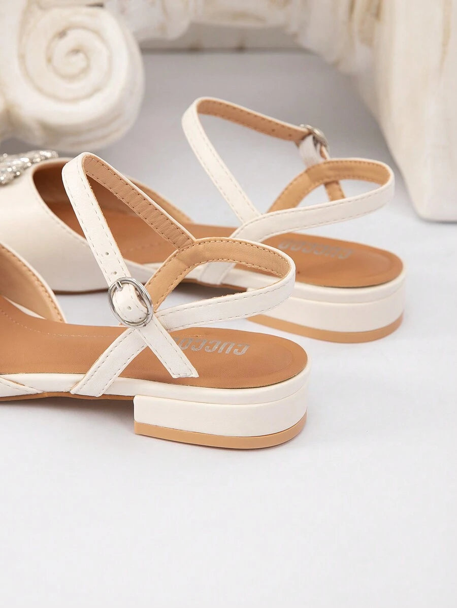 Rear sole detail of white PU leather slingback flats showing low block heel construction