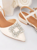 Overhead product view of white pointed toe flat showing crystal ornament and heel strap