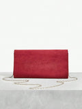 Close-up view of elegant riveted angola red clutch: perfect fashion accessory for valentine's day with riveted accents, clutch silhouette for party styling