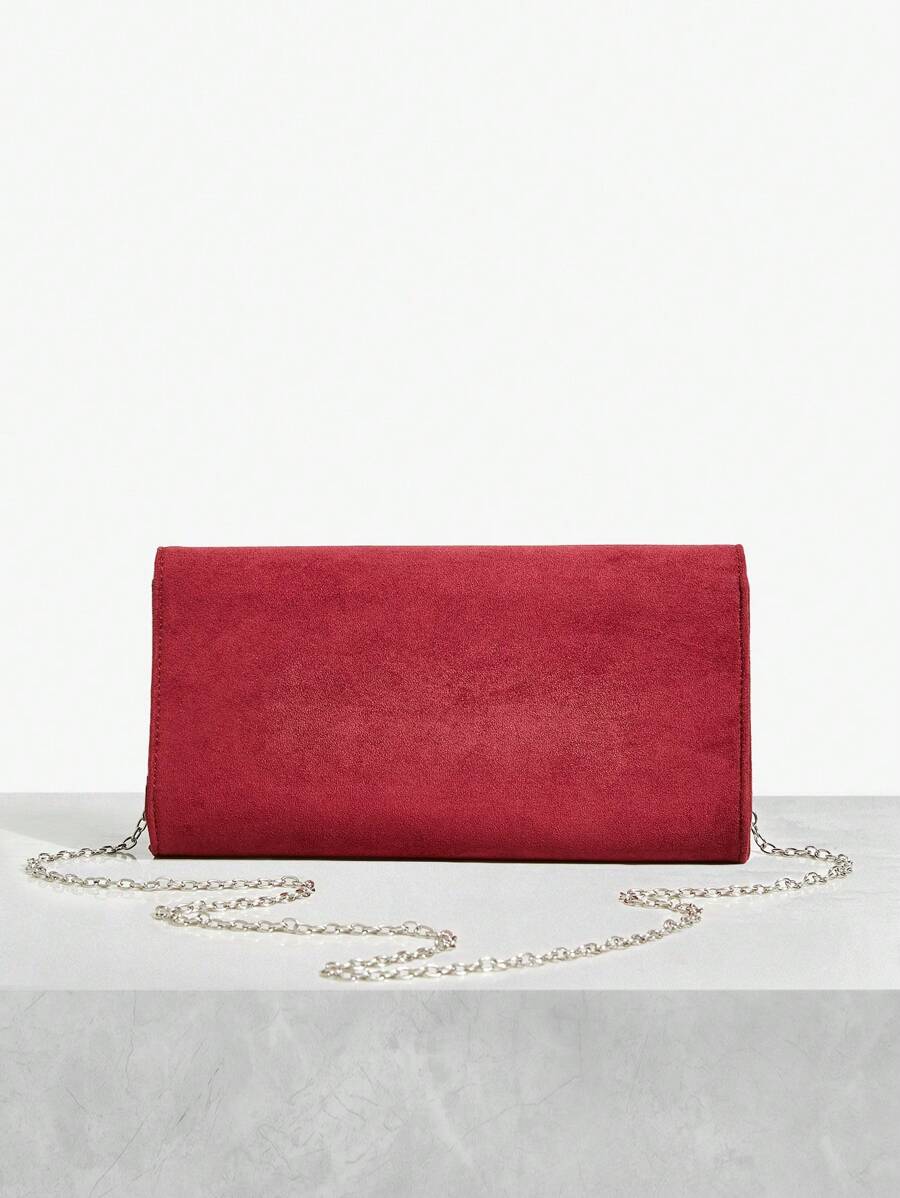 Close-up view of elegant riveted angola red clutch: perfect fashion accessory for valentine's day with riveted accents, clutch silhouette for party styling
