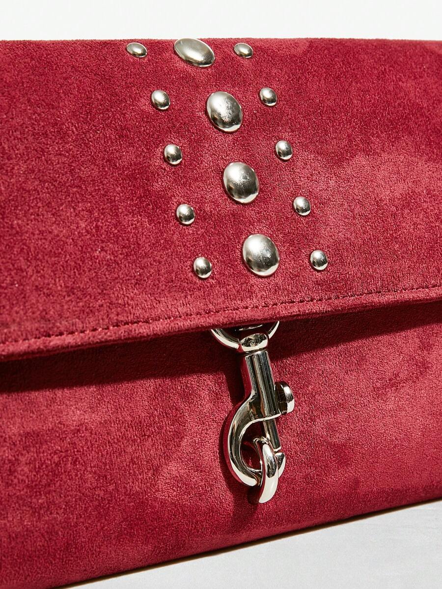 Close-up view of elegant riveted angola red clutch: perfect fashion accessory for valentine's day with riveted accents, clutch silhouette for party styling