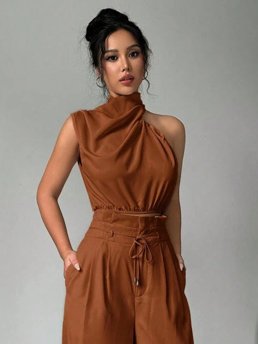 Elevate your office wardrobe with this sophisticated 2-piece set featuring a sleeveless turtleneck crop top paired with wide-leg pants. Crafted from 100% polyester woven fabric, this ensemble delivers an elegant, polished look perfect for professional settings. The top showcases an asymmetrical neckline with lace-up detailing, while the pants feature a convenient pocket and zipper closure for everyday functionality. In classic navy blue with a regular fit, this versatile set transitions seamlessly.