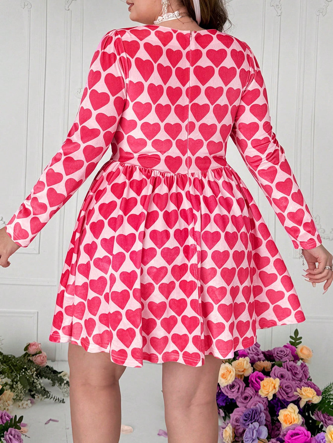 Get ready to turn heads this Valentine's Day with our Plus Size Velvet Heart Dress! Designed with elegant floral polka dots and cupid graphics, this dress is perfect for a romantic evening out. Show off your unique style and impress your date with this quirky and playful outfit choice. (Single and ready to mingle? This dress will definitely catch someone's eye!)