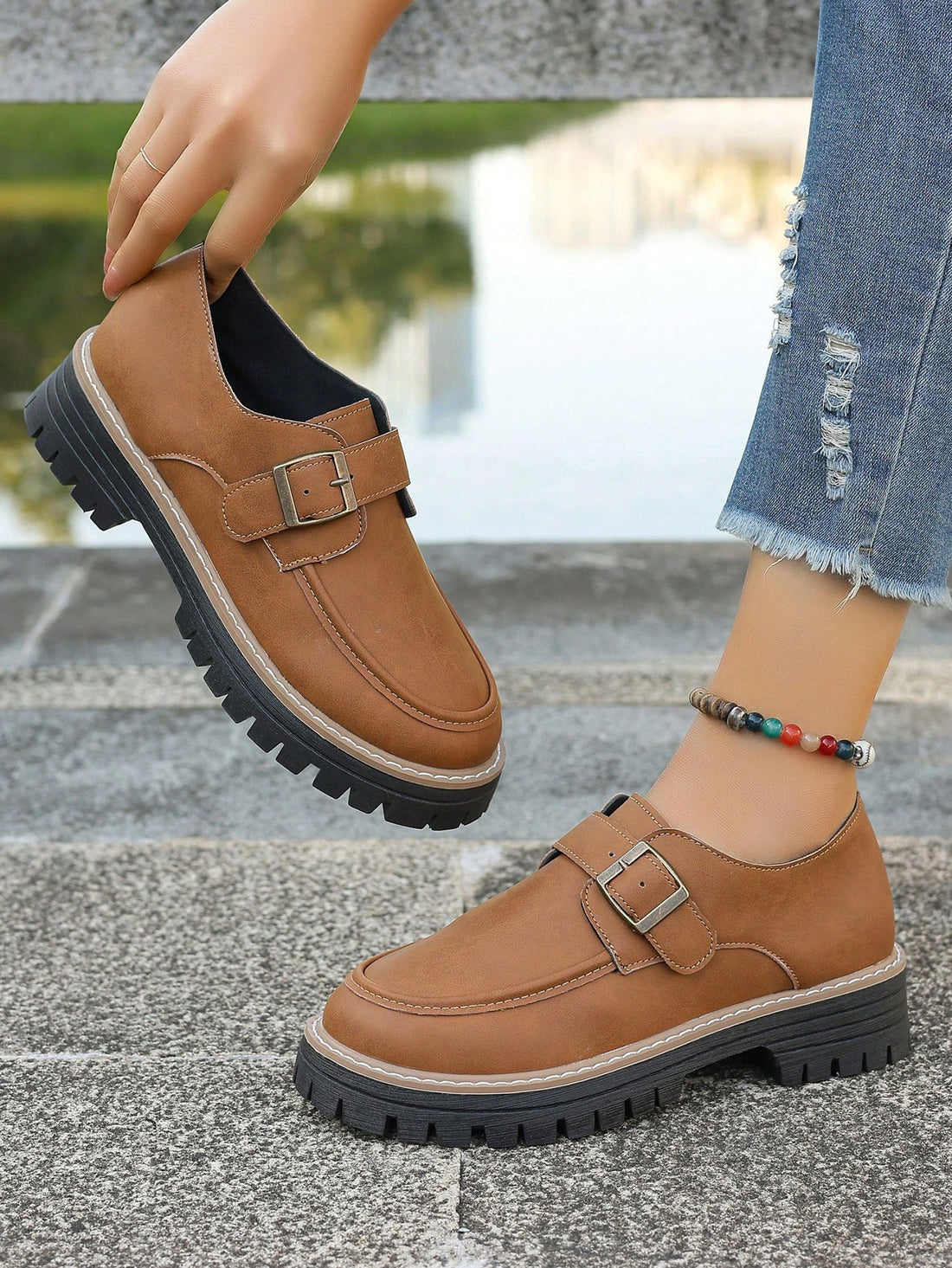 Step up your style with these trendy loafers! Featuring a chic buckle design and a thick sole, these shoes are perfect for fashionable students. Stay on trend and comfortable with these unique and stylish loafers. (Only 39 words - under 50!)