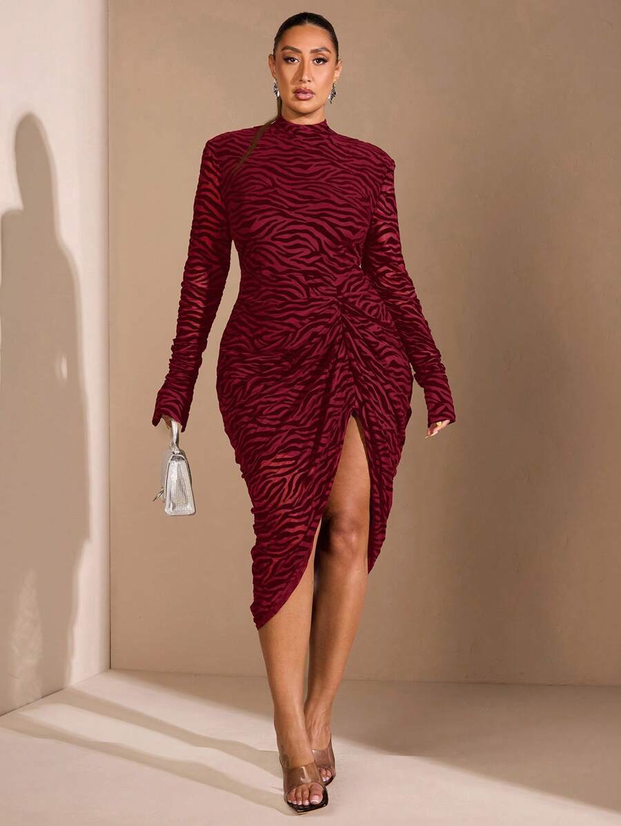 Step into the spotlight with this plus size black zebra print mesh dress, perfect for fall and winter. Featuring a chic high neck and long sleeves, it keeps you cozy while turning heads. The daring high slit adds a flirty twist, making every step a statement. Embrace elegance with a wild side!