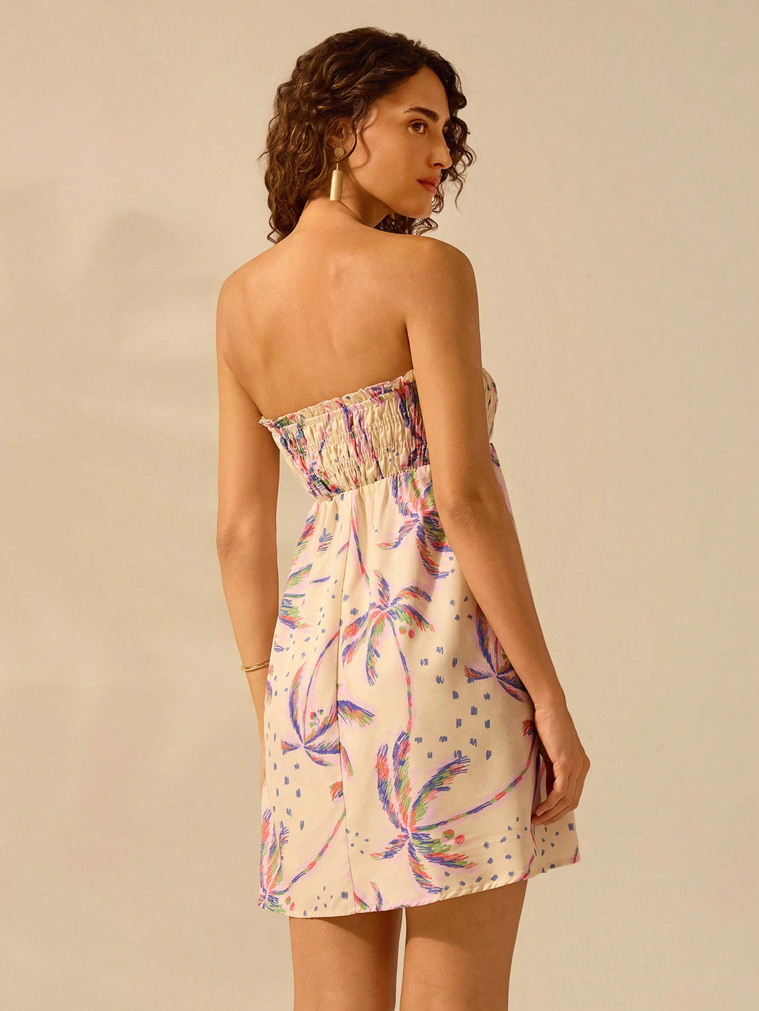 Experience a tropical escape with Boho Bliss's Purple Tropical Coconut Tree Print Ruffled Mini Dress. Perfect for summer vacations, this dress will have you feeling like you're on a beach getaway with its playful ruffled design and vibrant print. Soak up the sun in style with this must-have dress.