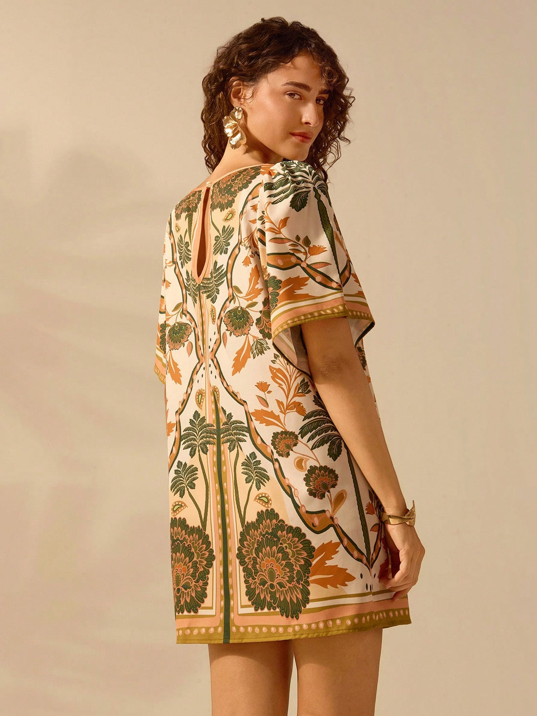 Get ready to escape to paradise with our Tropical Escape Mini Dress! Flirty ruffle sleeves and an open back add a touch of boho to this summer essential. Perfect for your next beach vacation. (Warning: May cause major island vibes!)